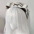 White leather rivet headband from the sharp claw kitty leather collection with silver spikes and black lace-up details