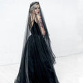 Black velvet gown with sheer bride wedding black veil and delicate floral headpiece for elegant bridal look