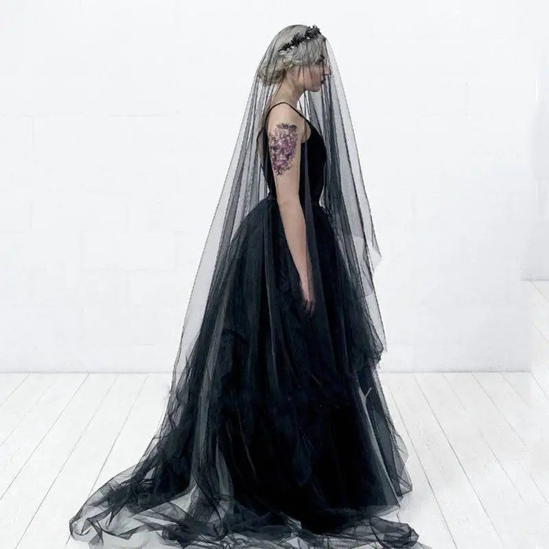 Black veil made of delicate sheer fabric draping over the model’s head and shoulders for sheer bride wedding use