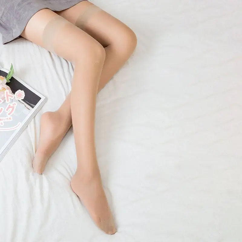 Sheer beige thigh-high socks with opaque elastic bands offering a white sheer high knee look and comfortable fit