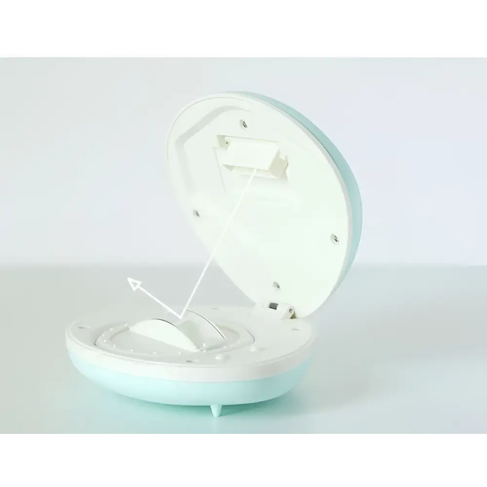 A pastel blue and white circular alarm clock with hinged lid showing internal mechanism for shell rainbow projection use