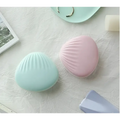 Pastel blue and pink seashell-shaped compact mirrors with a glossy finish for shell rainbow projection hair removal light