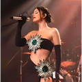 A black strapless slit skirt bandage suit with shiny rhinestone tube material and emerald crystal sunburst embellishments
