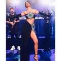 Black strapless shiny rhinestone tube skirt bandage suit with emerald center and high slit skirt bandage design