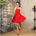 Short tube top bride wedding dress featuring a vibrant red strapless cream-colored tulle skirt with a large bow