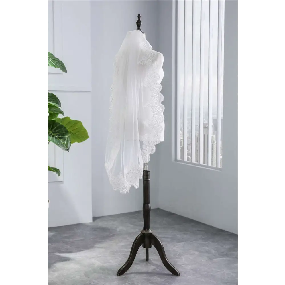 Short veil soft mesh sequined lace white ivory with delicate floral patterns draped elegantly over a mannequin head