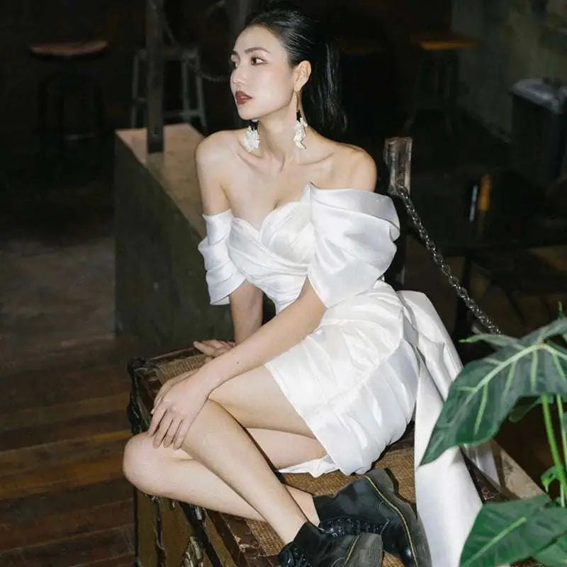 Short white color engagement dress featuring white satin off-the-shoulder design with voluminous puffed sleeves