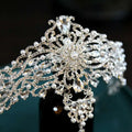 Silver baroque bride crown featuring an ornate silver tiara adorned with crystals pearls and intricate filigree detailing