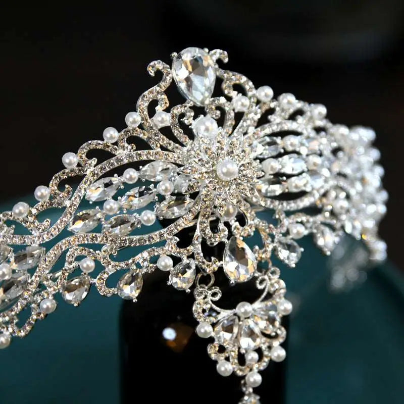 Silver baroque bride crown featuring an ornate silver tiara adorned with crystals pearls and intricate filigree detailing