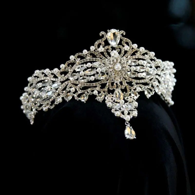 Silver baroque bride crown adorned with clear crystal and pearl accents featuring an ornate floral design