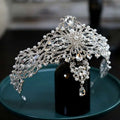 Silver baroque bride crown adorned with clear crystals, teardrop pendants, and delicate pearl accents for brides