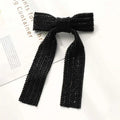 Black beaded bow hair clip with elegant herringbone weave pattern and silver beaded bow accents with glass diamonds
