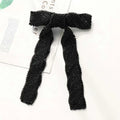 Black beaded bow with herringbone pattern paired with silver beaded bow hair clip adorned with glass diamonds