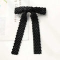 Black beaded bow hair clip with diamond-patterned mesh design and silver glass diamond accents for elegant styling