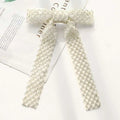 Silver beaded bow hair clip featuring an elegant off-white mesh with shimmering glass diamond pattern design