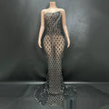 A shimmering silver beaded sexy elegant fishtail gown with a strapless bodice and sheer diamond-patterned skirt
