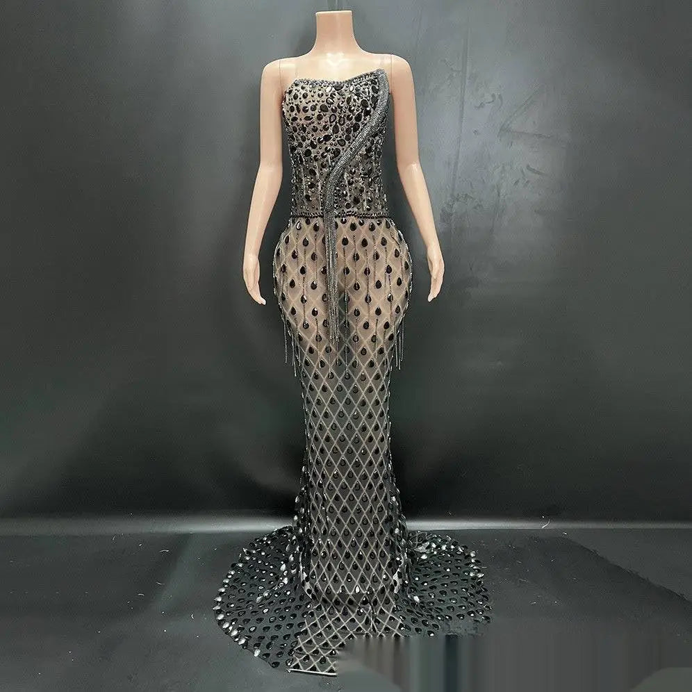 A shimmering silver beaded sexy elegant fishtail gown with a strapless bodice and sheer diamond-patterned skirt
