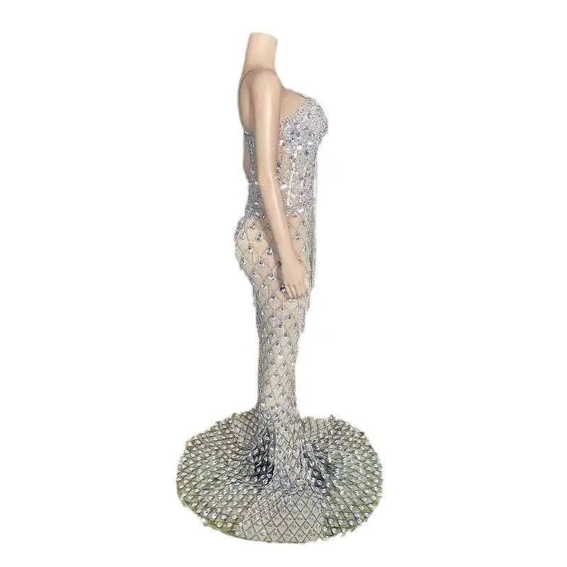 A shimmering silver beaded sexy elegant fishtail gown with one-shoulder design and an expansive beaded train