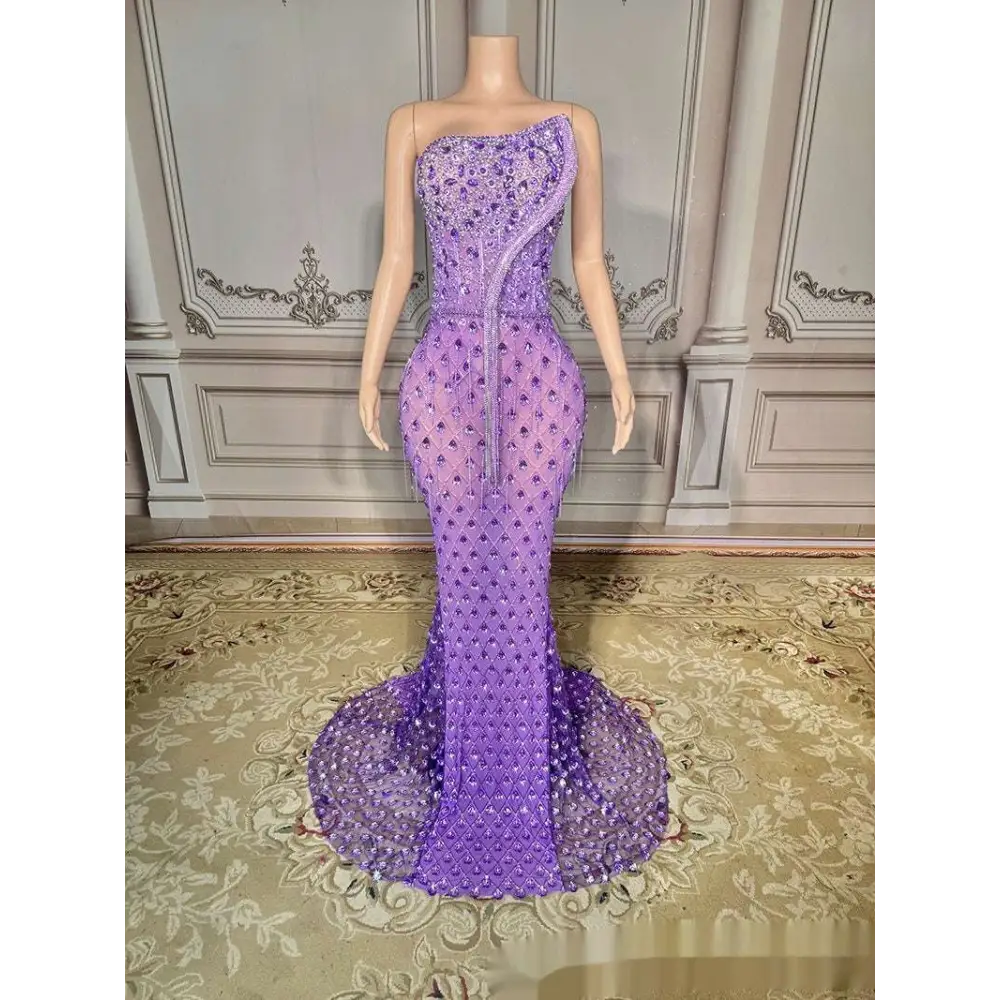 A shimmering silver beaded sexy elegant fishtail gown in lavender with intricate beading and a sheer fitted bodice