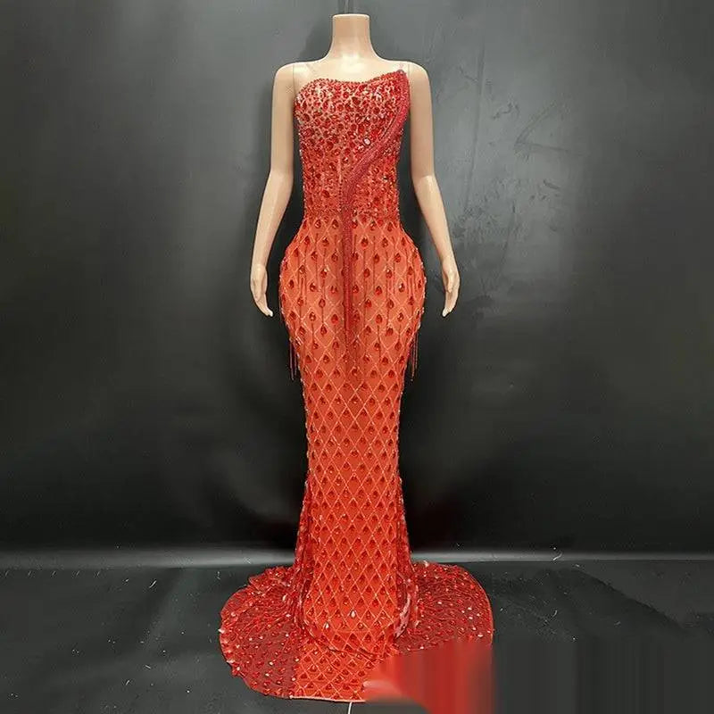 A striking red strapless mermaid-style gown with shimmering silver beaded detailing and an elegant fishtail silhouette