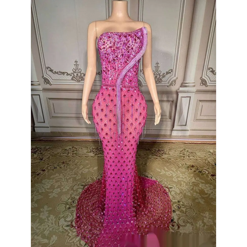 A dazzling fuchsia sexy elegant fishtail gown with intricate beading and a shimmering silver beaded diagonal strap