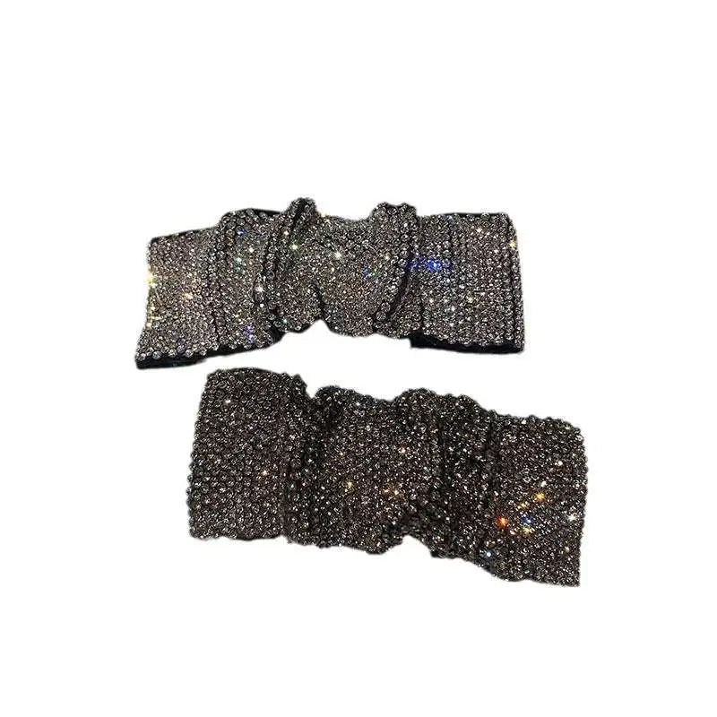 Silver bow pleated bb clip featuring hot rhinestone details with a shimmering black rhinestone bow and ruched texture