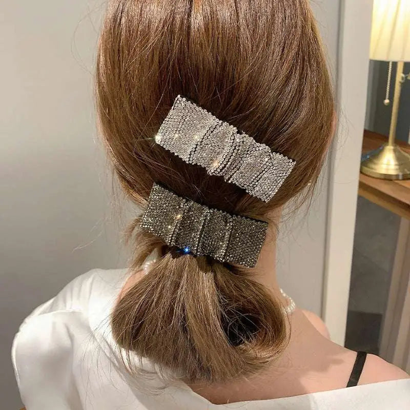 Two silver bow pleated bb clips featuring hot rhinestone details with rectangular and bow shapes densely covered in crystals