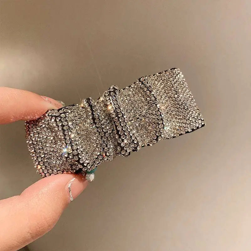 Silver bow pleated bb clip featuring hot rhinestone details in a sleek structured design with silver rhinestones