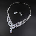 A silver bride headdress necklace jewelry suit with cascading pear-shaped and round-cut crystals and a teardrop pendant