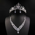 A silver bride headdress crown and matching necklace jewelry suit featuring floral designs and teardrop crystals