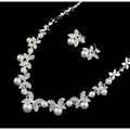 Silver butterfly bride wedding jewelry set featuring a silver necklace with butterfly and leaf motifs adorned with pearls