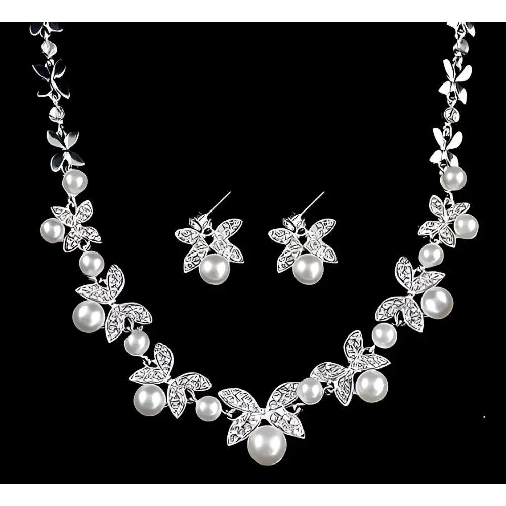 Silver butterfly bride wedding jewelry set featuring a silver butterfly-themed necklace and matching pearl accented earrings
