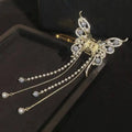 Gold-toned butterfly grab hair clip adorned with gray gemstones pearls and rhinestones temperament bow tassel accessory