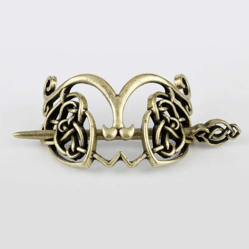 Antique brass-colored metal hair clip with intricate silver celtic knot design for retro style hair accessory