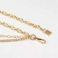 Gold-toned padlock clasp and carabiner hook on a silver chain belt designed as summer body jewelry and jewelry hip hop