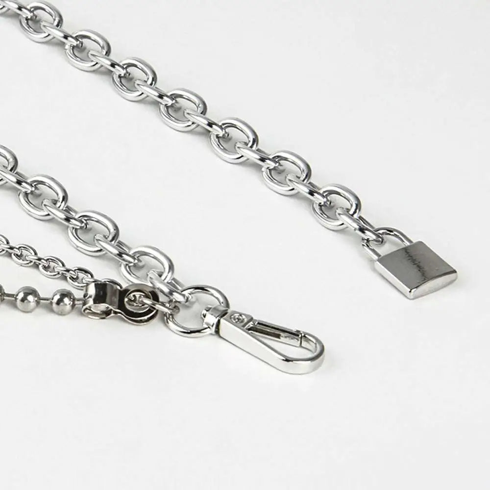 Silver chain belt featuring a padlock charm and carabiner clip as summer body jewelry for jewelry hip hop style