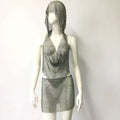 Silver chainmail halter top and mini skirt set featuring a fishnet rhinestone tight design in a silver rhinestone tight suit