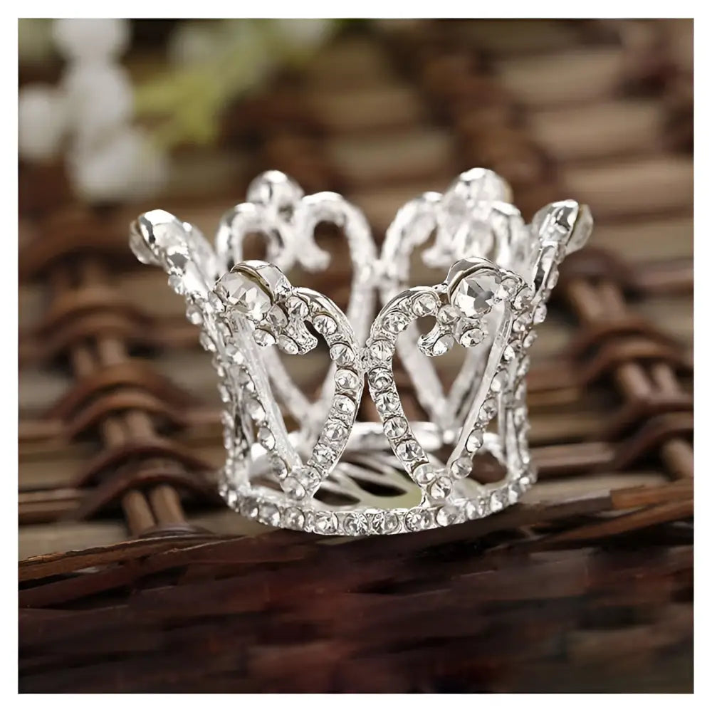 A delicate silver childrens hair comb crown featuring sparkling crown rhinestone accessories in an intricate design