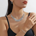 A sparkling silver multi-tiered choker necklace adorned with clear crystals from the silver claw chain set