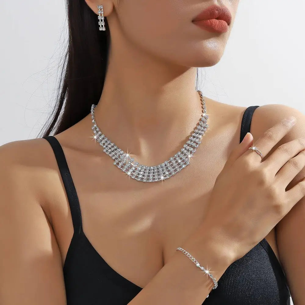 A sparkling silver multi-tiered choker necklace adorned with clear crystals from the silver claw chain set