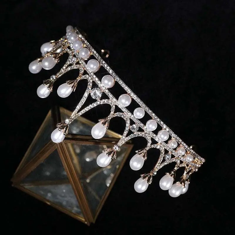 Gold-toned rhinestone pearl tiara with elegant leaf design and dangling white pearls for pearl baroque headwear