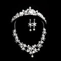 Silver crystal alloy headdress bridal crown adorned with intricate crystal flowers and delicate pearls for weddings