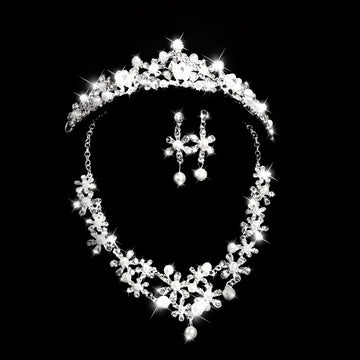 Silver crystal alloy headdress bridal crown adorned with crystals and pearls paired with matching floral earrings