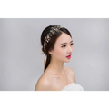 Delicate silver crystal bridal hair accessory with gold-toned floral design and sparkling clear crystals