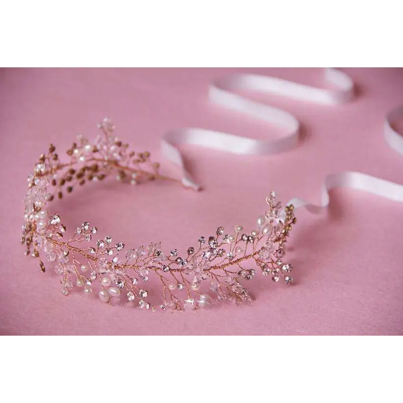 Silver crystal bridal hair accessory in rose gold with clear crystals and freshwater pearls in a delicate leafy design