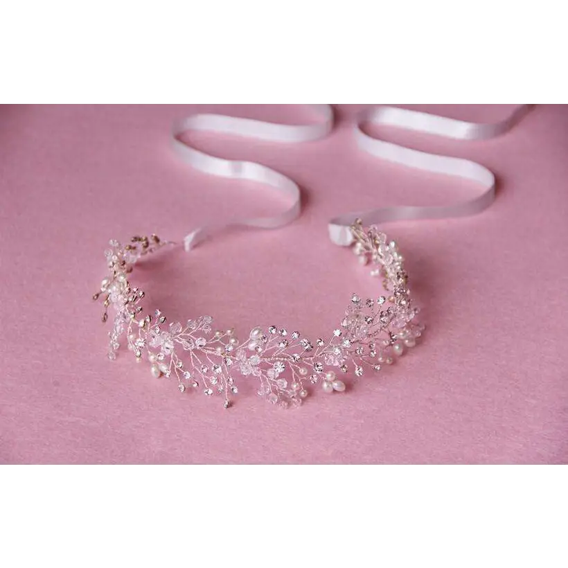Delicate silver crystal bridal hair accessory featuring a silver-toned floral design with crystals and tiny pearls
