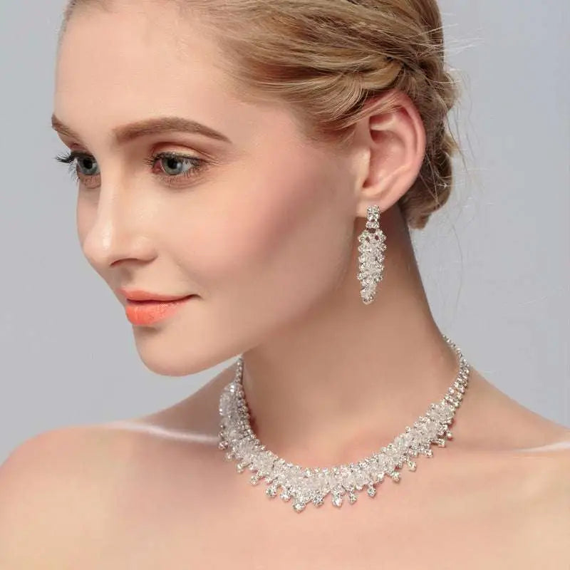 A silver crystal choker wedding jewelry set featuring a cascading crystal design with matching dangling earrings