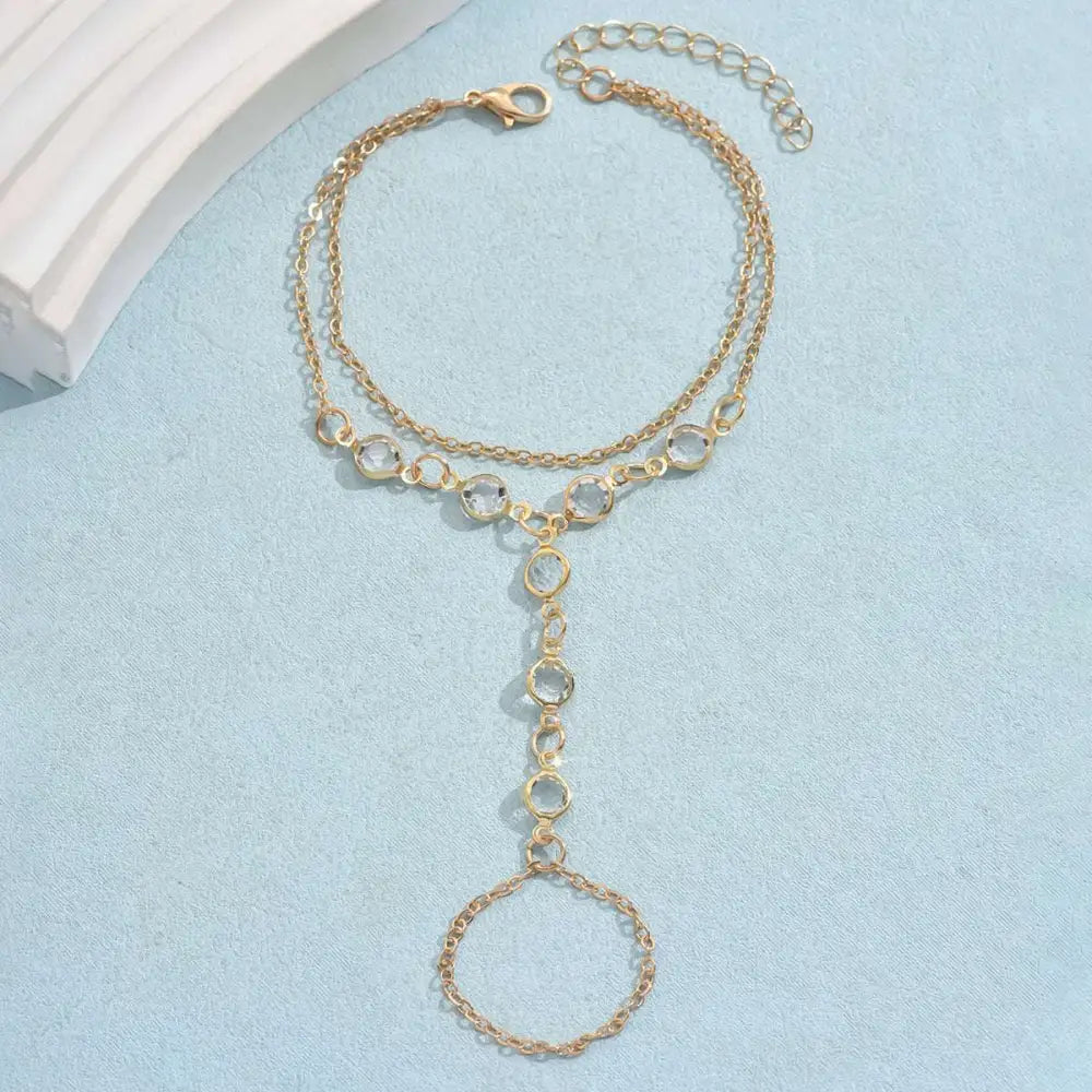 Gold-toned layered anklet with clear crystal accents and delicate chain design complements silver crystal fashion minimalist bracelet ring