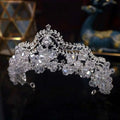 A sparkling silver crown baroque featuring clear crystal leaf bridal flowers and intricate leaf-like embellishments