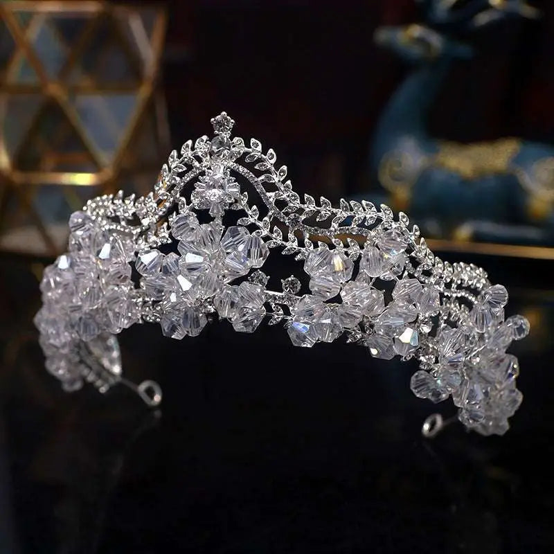 A sparkling silver crown baroque featuring clear crystal leaf bridal flowers and intricate leaf-like embellishments